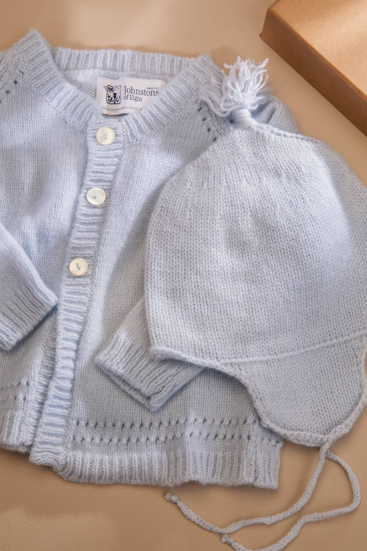 Johnstons of Elgin’s Baby's 1st Cashmere Cardigan Gift Set in Powder Blue on a beige background AW21GIFTSET19C