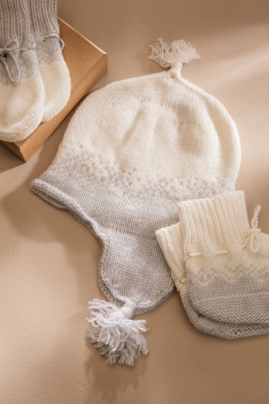 Johnstons of Elgin Gift Set includes our Cashmere Ombre Baby Hat, Mittens & Booties in Pumice on grey background AW21GIFTSET22A