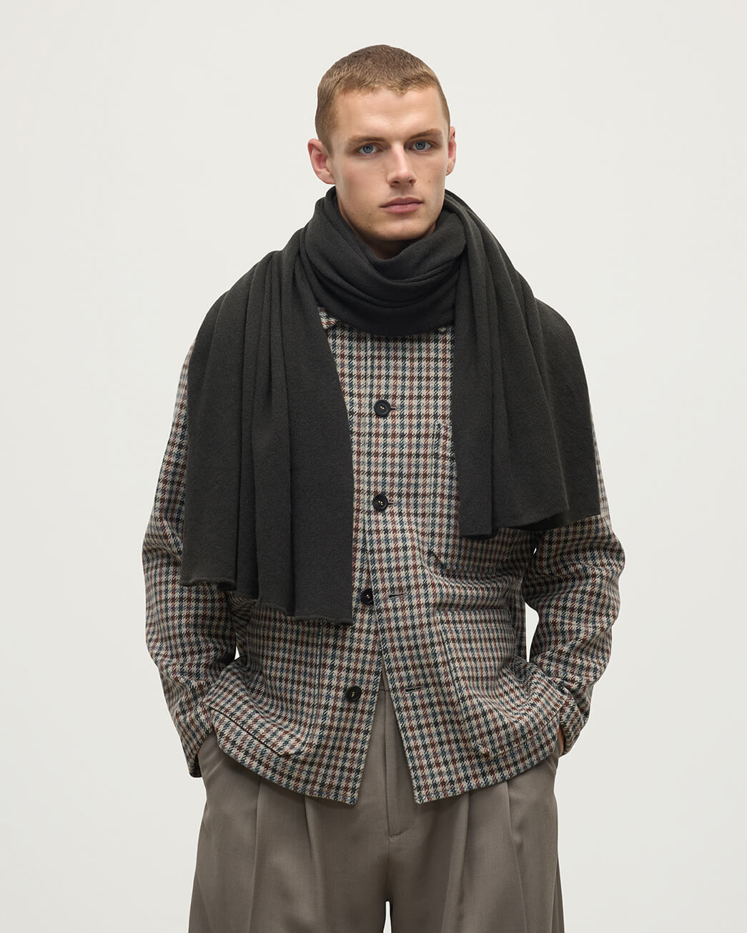 Model wears Johnstons of Elgin dark grey gauzy cashmere travel stole HAA03407SC7330ONE