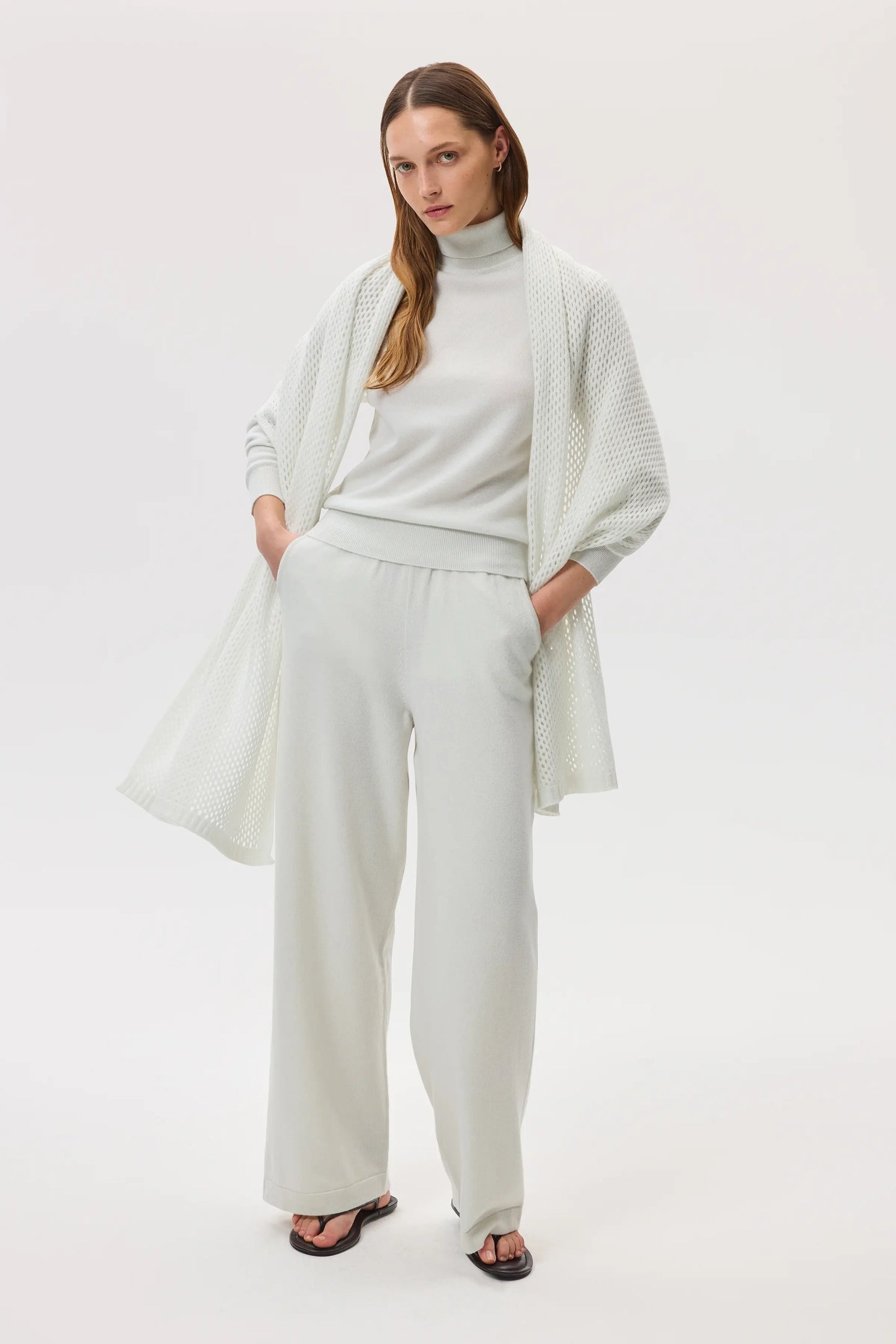 Model wearing Johnstons of Elgin SS25 Accessories White Crochet Cashmere Stole, with white cashmere roll neck and wide leg culottes
HAC05040HA0346ONE