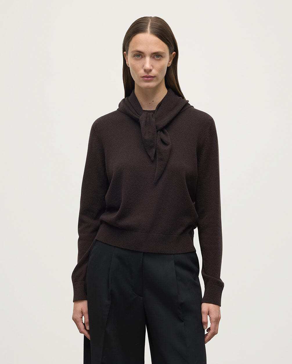 Model wearing Johnstons of Elgin Molasses brown cashmere neck tie, worn with a dark brown cashmere sweater HAE03430SB7290ONE