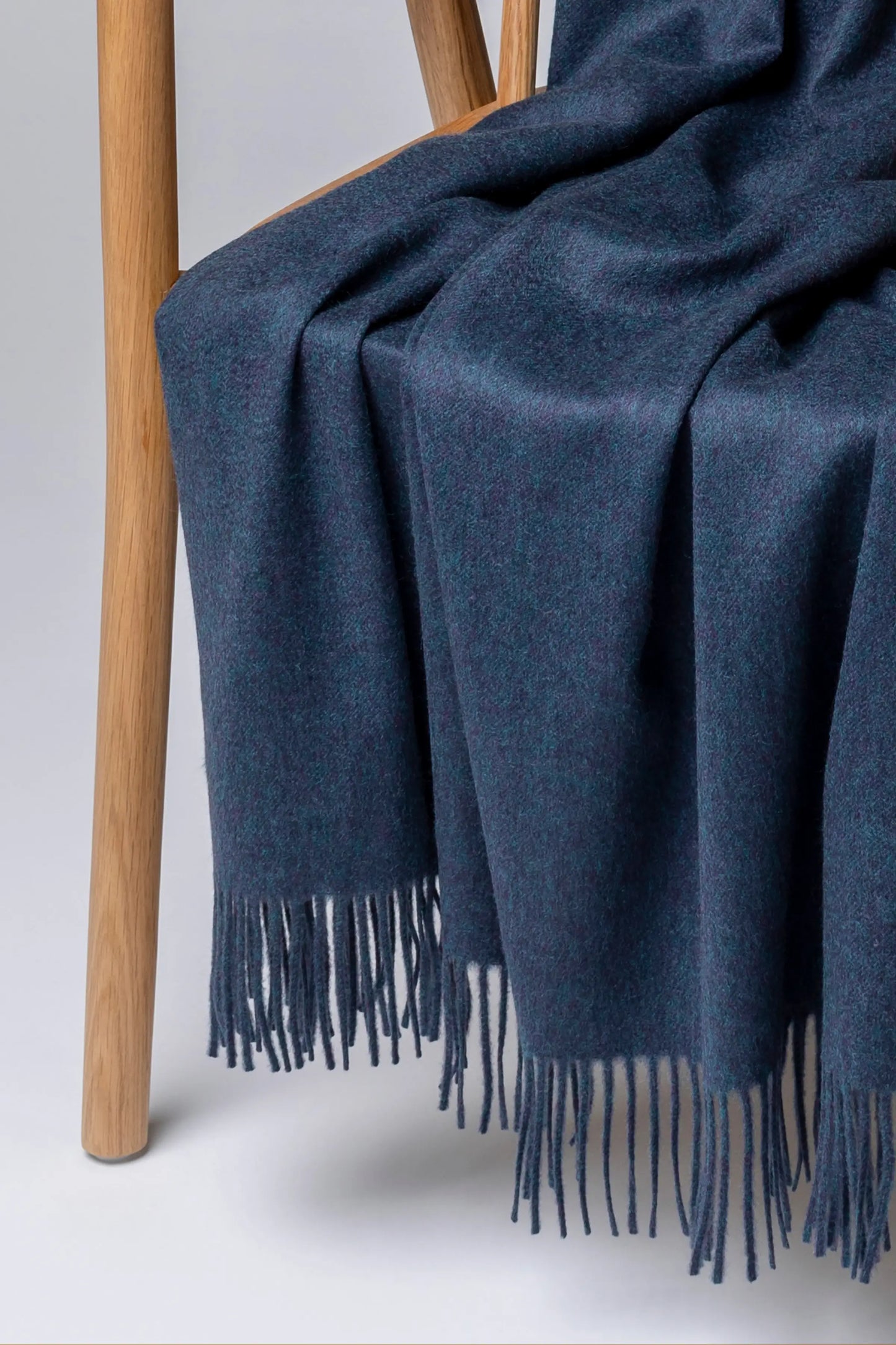 2025 Johnstons of Elgin Interiors Collection Heather Navy Heather Navy Cashmere Throw on a grey background WA000055HD7311ONE