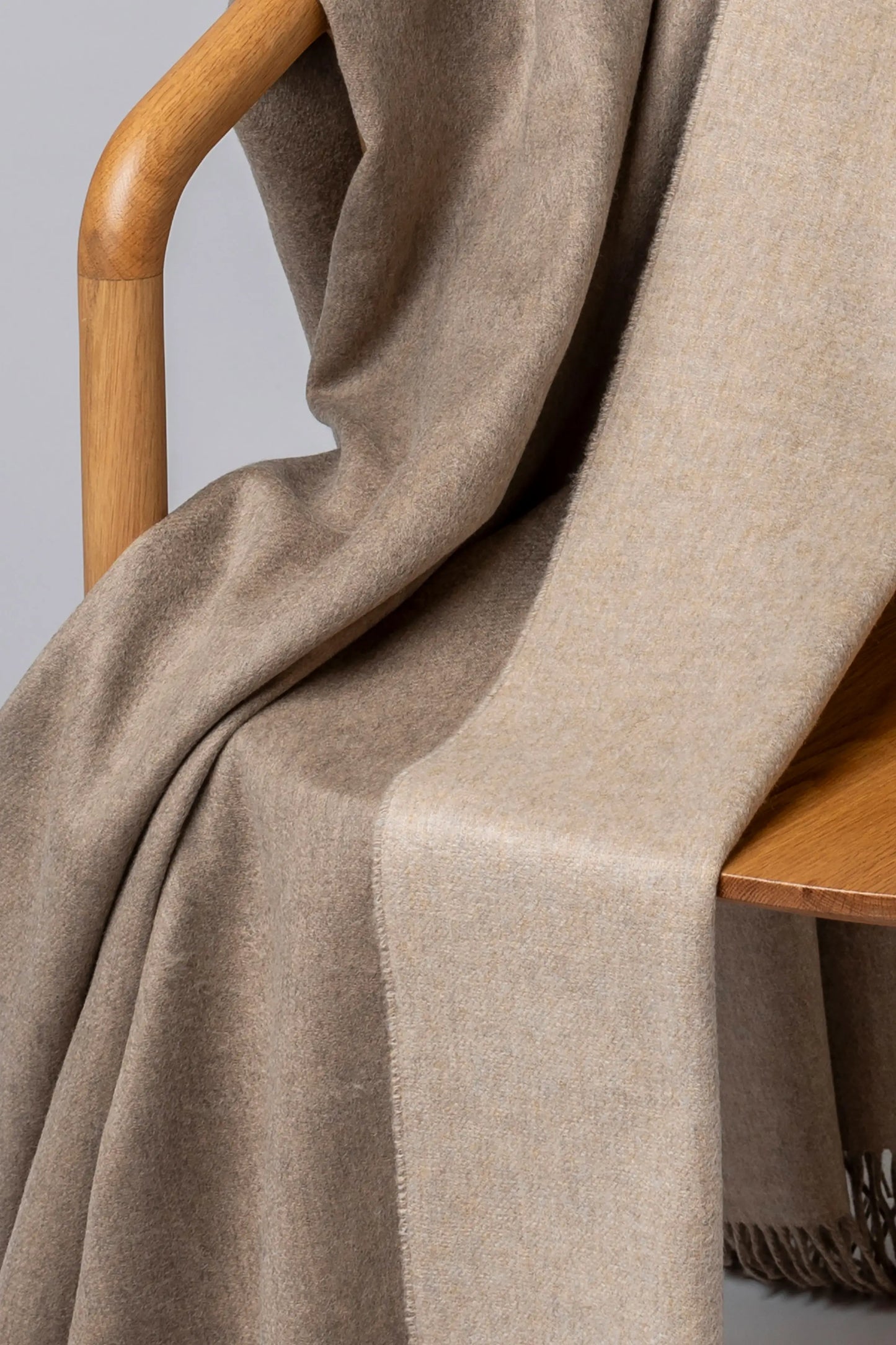2025 Johnstons of Elgin Interiors Collection Otter & Oatmeal Reversible Cashmere Throw on a grey background WA000013RU7622ONE