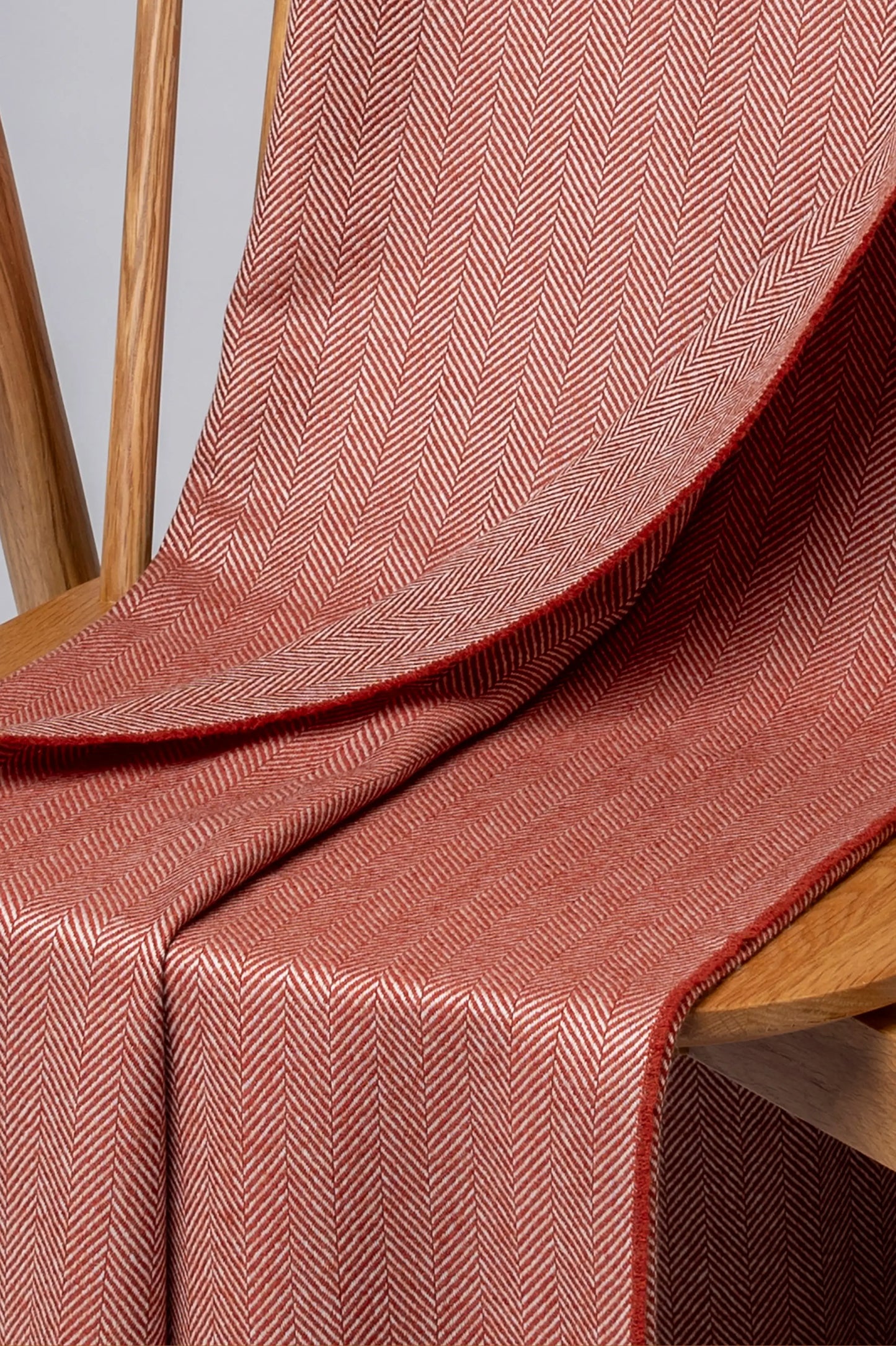 2025 Johnstons of Elgin Interiors Collection Rowan & White Herringbone Merino Throw on a grey background WD000010RU7608ONE