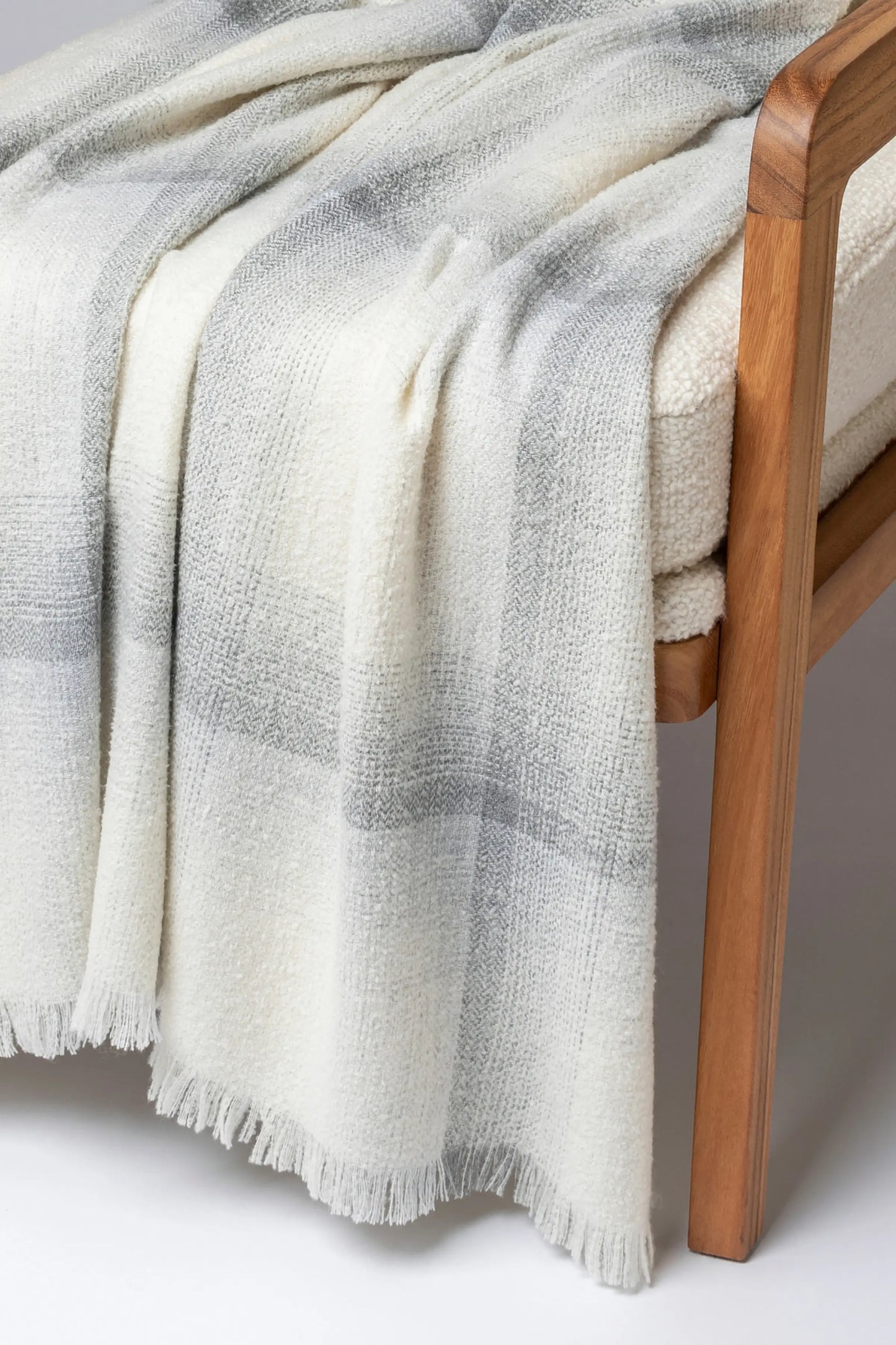 2025 Johnstons of Elgin Interiors Collection Ecru Blurred Bouclé Throw on a grey background WB002788RU7669ONE