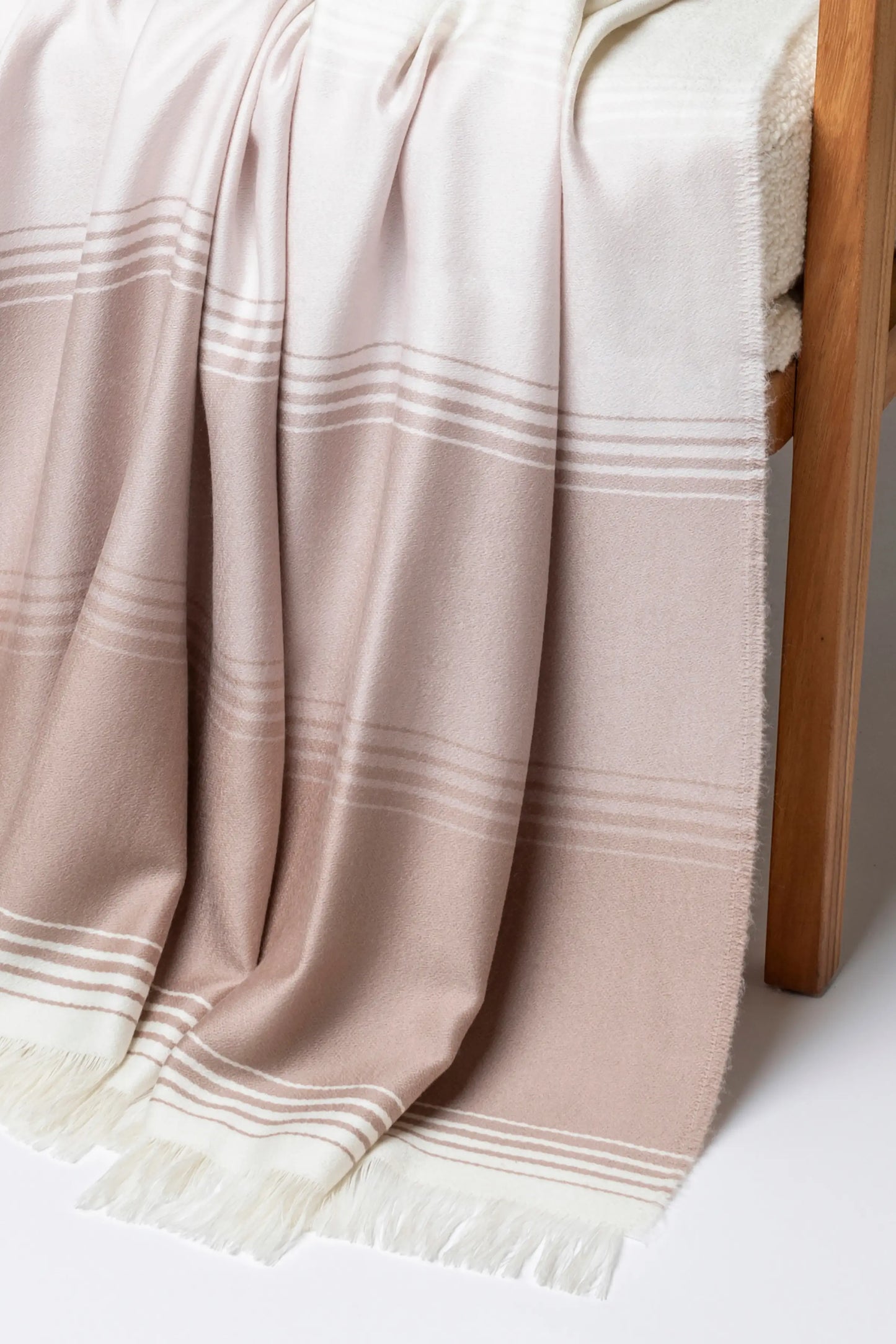 2025 Johnstons of Elgin Interiors Collection Camel & Pink Diffused Stripe Merino Wool Throw on a grey background WD000257RU7610ONE