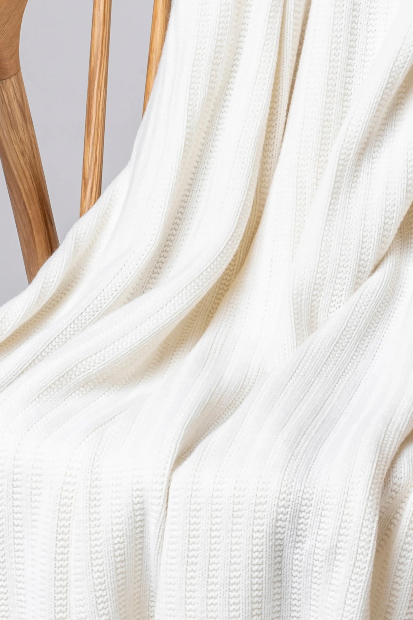 2025 Johnstons of Elgin Interiors Collection Zinc White Texture Knitted Cashmere Throw on a grey background HAI03061SA0606ONE