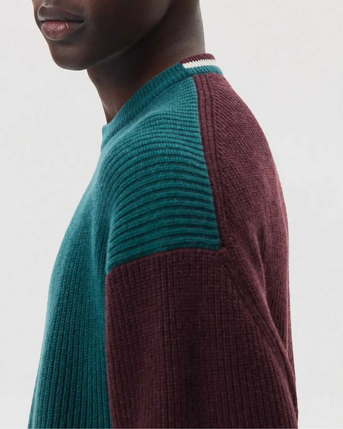 Model wears Johnstons of Elgin SS25 Men's Knitwear Rosewood & Emerald Colour Block Relaxed Cashmere Jumper on a white background KAA05412Q25137