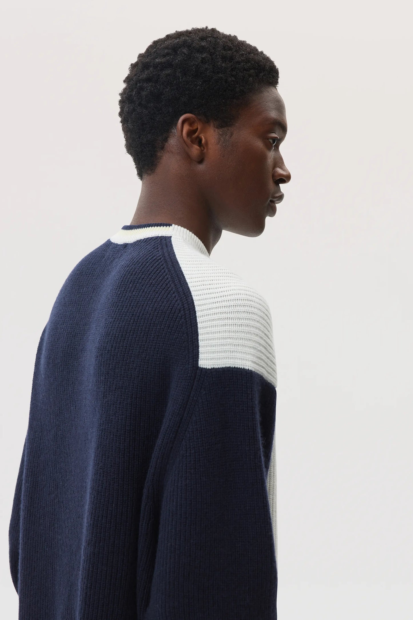 Model wears Johnstons of Elgin SS25 Men's Knitwear Navy & White Colour Block Relaxed Cashmere Jumper KAA05412Q25138