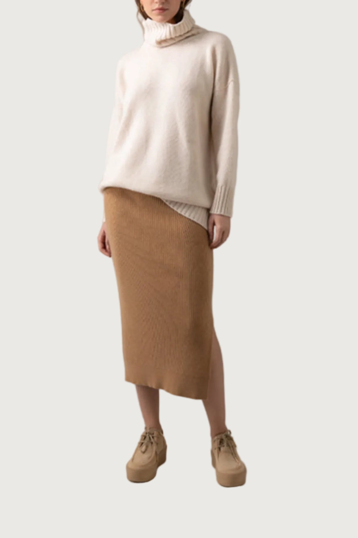 Johnstons of Elgin Ribbed Tube Cashmere Skirt in Camel worn with matching Slim Fit Cashmere Sweater on a grey background KBP00923HB4315
