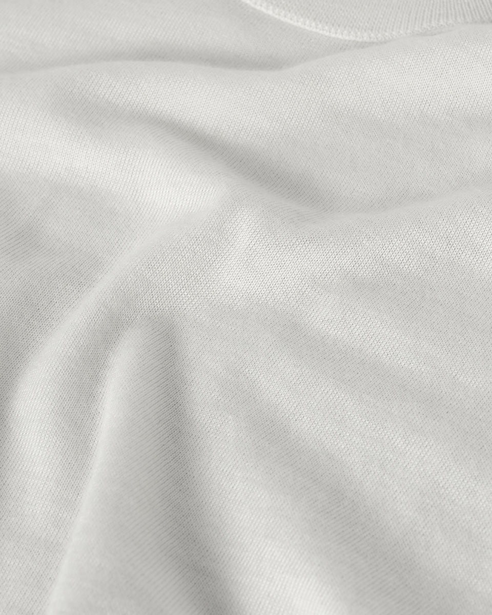 Johnstons of Elgin AW25 Men's Knitwear White Superfine Cashmere V Neck Jumper against a white backdrop KAI05242HA0327