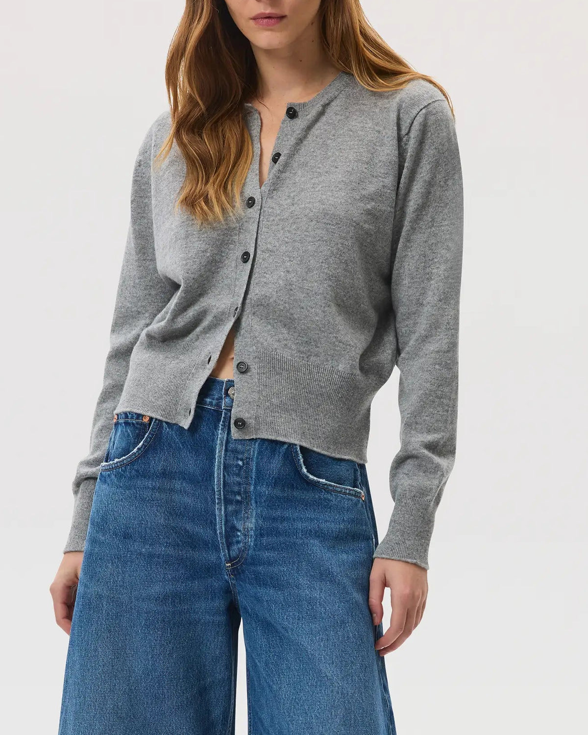 Model wears Johnstons of Elgin SS25 Women's Knitwear Light Grey Classic Cashmere Cardigan with blue jeans on a white background KAI05274HA0308