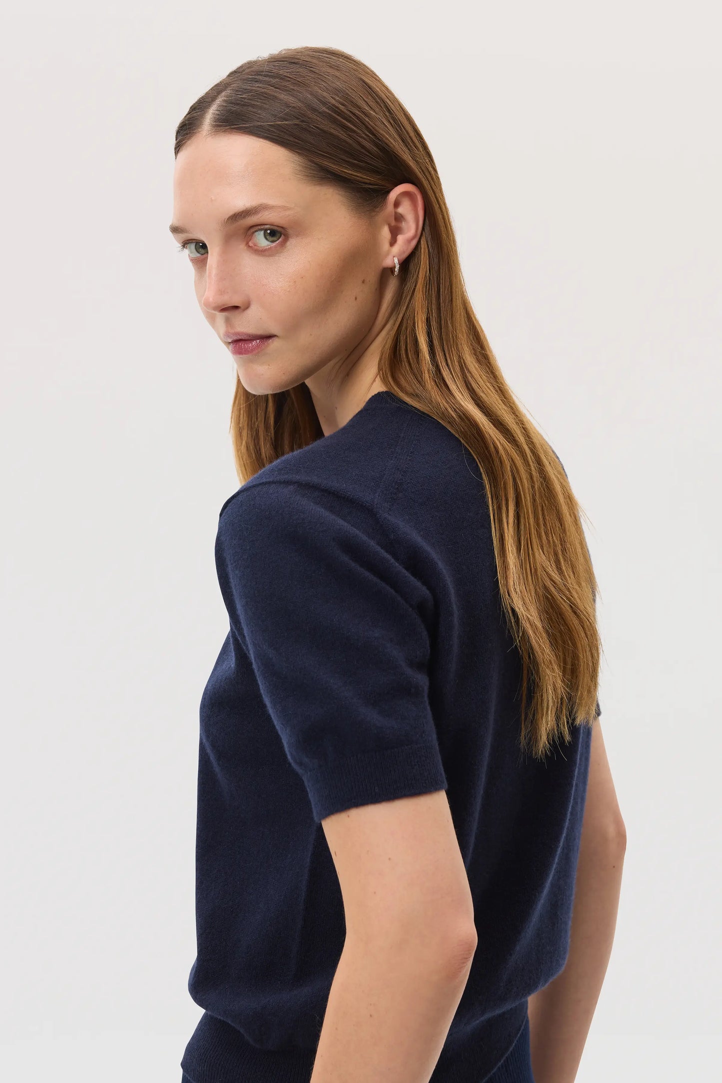 Model wears Johnstons of Elgin SS25 Women's Knitwear Navy Classic Cashmere T-Shirt KAI05371SD7286
