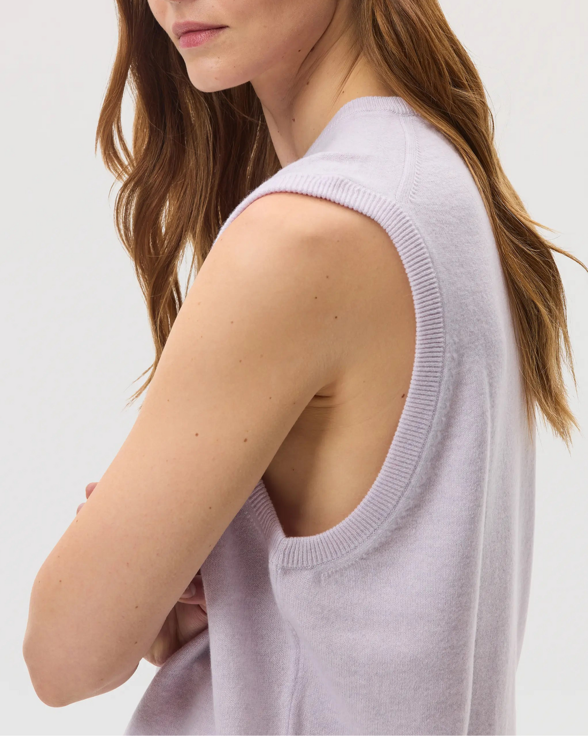 Female model wearing Johnstons of Elgin SS25 Unisex Knitwear Lavender Cashmere Tank against a white backdrop KAP05243HD0086