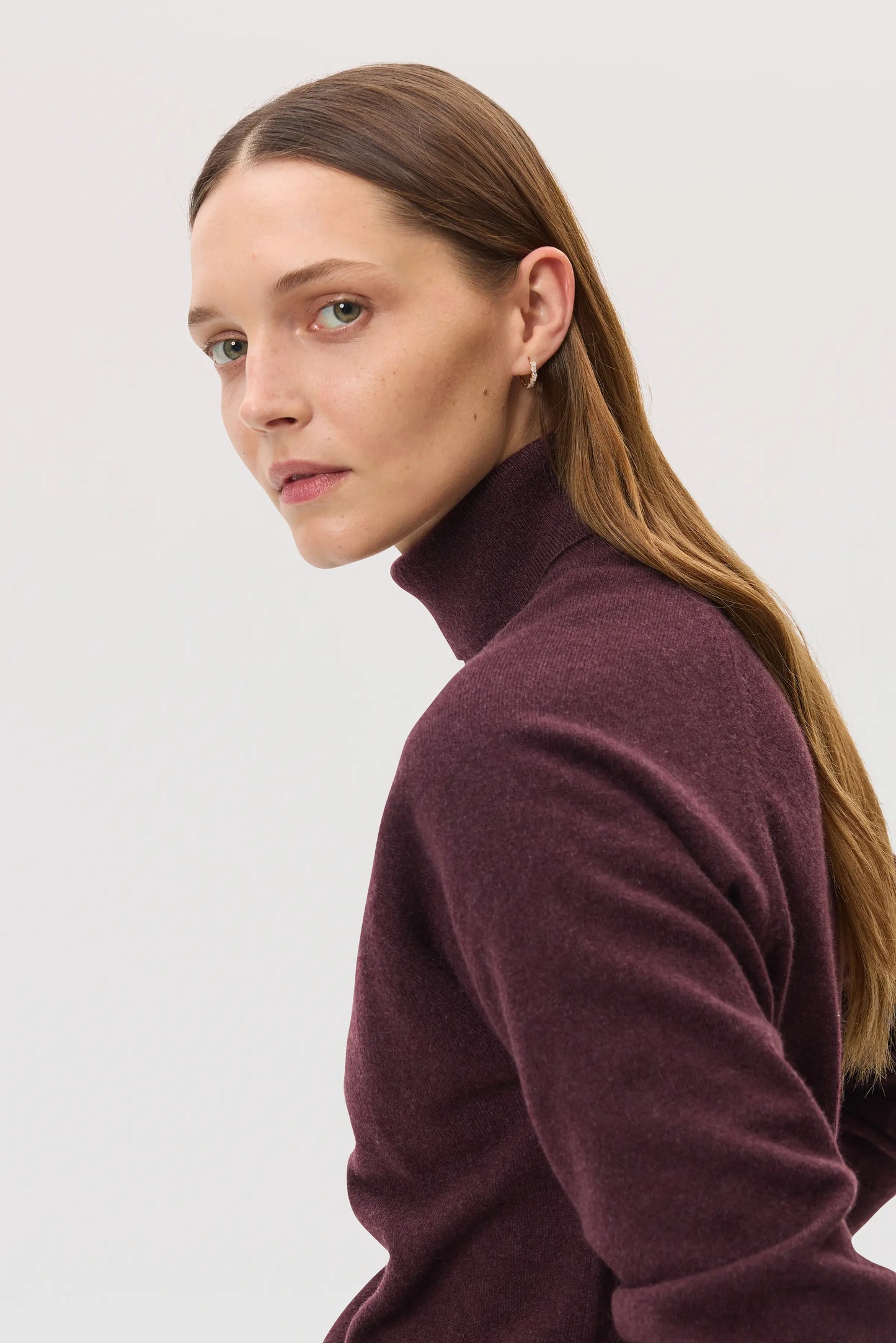 Model wears Johnstons of Elgin SS25 Women's Knitwear Rosewood Classic Cashmere Roll Neck Sweater with matching cashmere culottes KAP05275SB7089