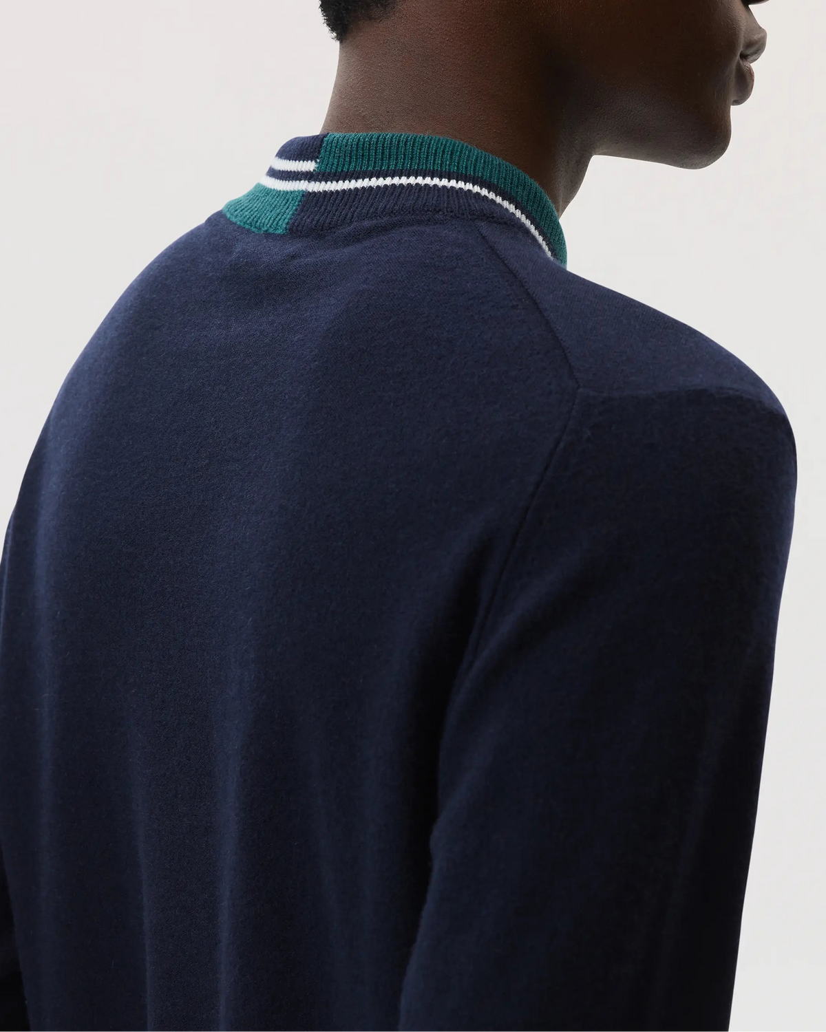 Johnstons of Elgin SS25 Men's Knitwear Navy Cashmere V Neck Sweater with Striped Trim in emerald on a white backdrop KAP05410Q25119