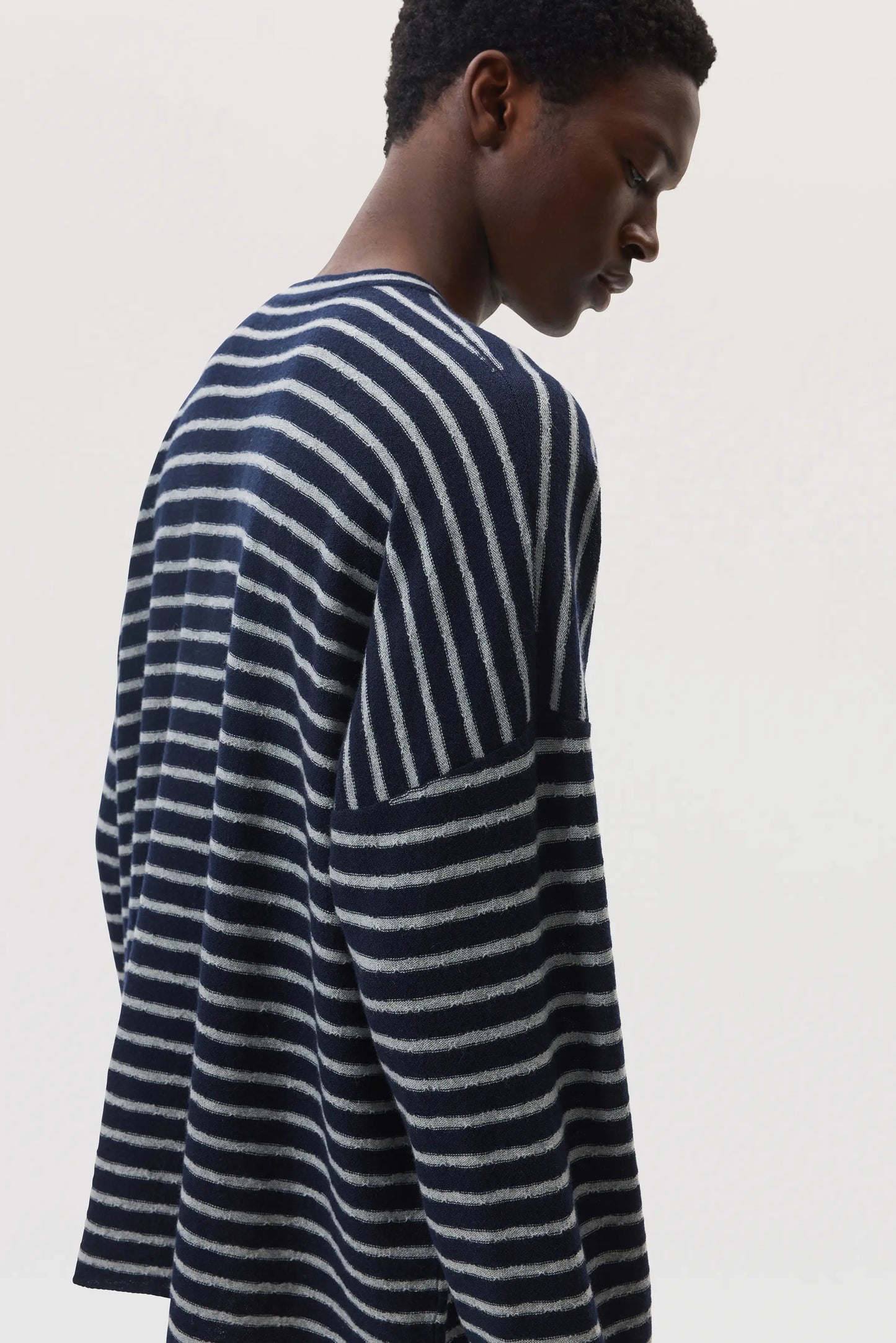 On a white back drop Johnstons of Elgin SS25 Men's Knitwear Navy & Light Grey Cashmere Jersey Stripe Oversized T-Shirt KAP05442Q25133