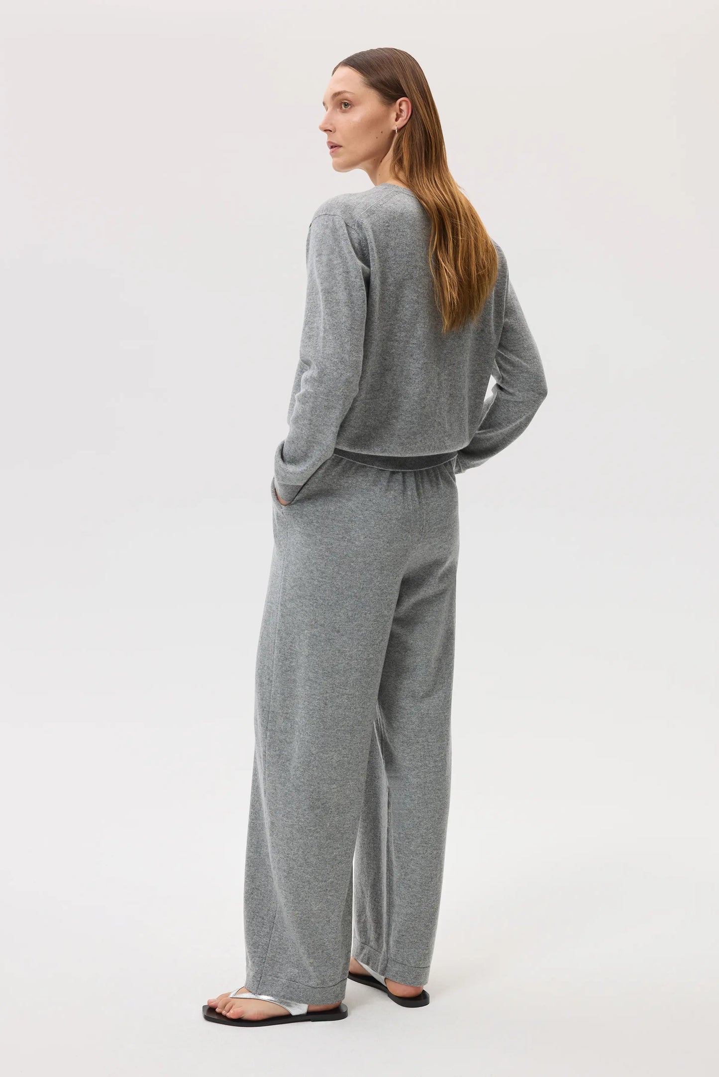 Model wearing Johnstons of Elgin SS25 Women's Knitwear Light Grey High Rise Cashmere Culottes with light grey cashmere crew neck sweater KBP00926HA0200