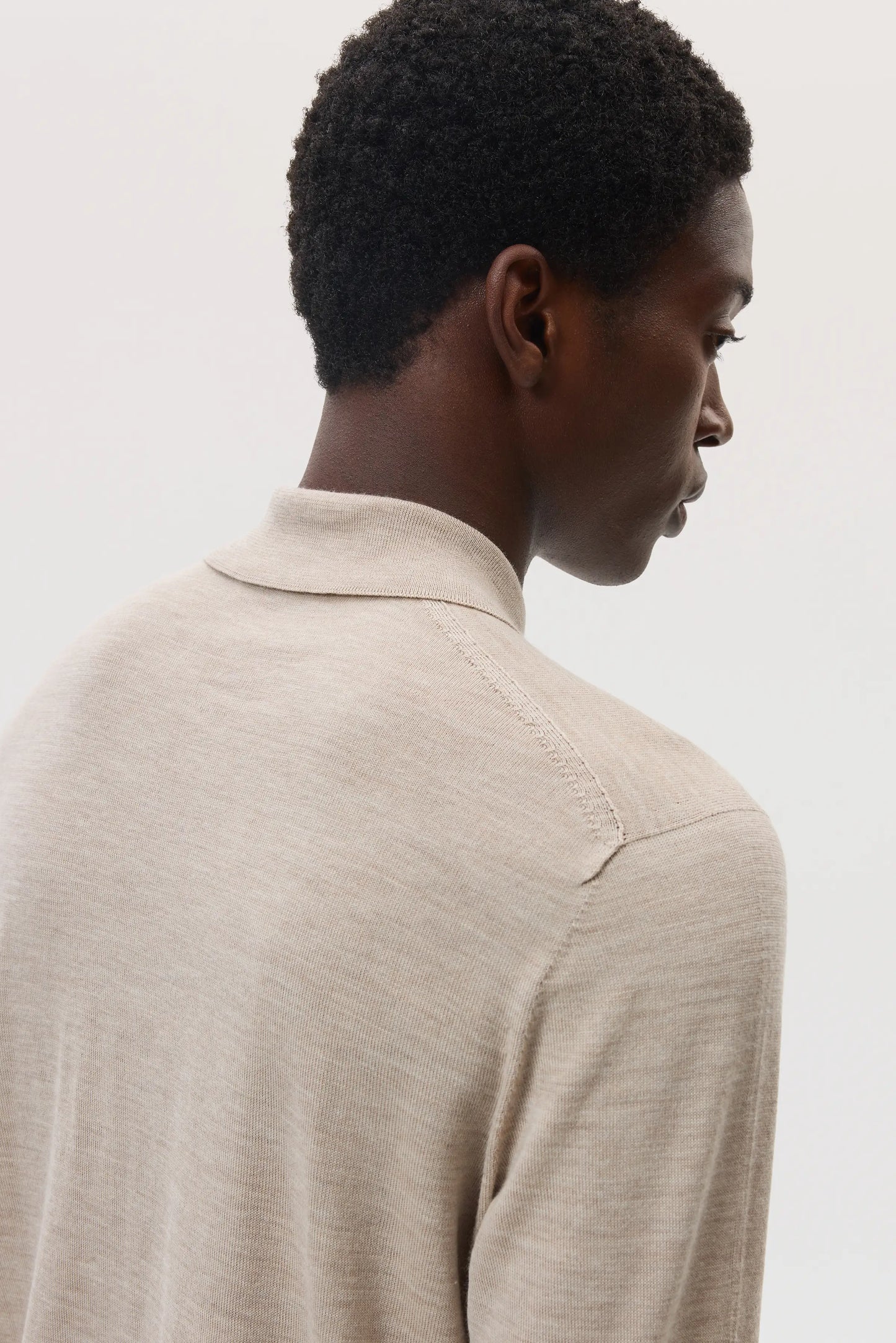 Male model wearing Johnstons of Elgin SS25 Men's Knitwear Natural Merino Long Sleeve Poloshirt KDI00706SB0695
