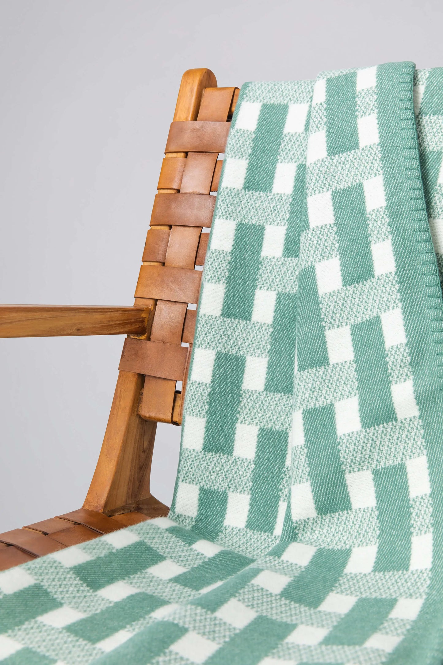 2025 Johnstons of Elgin Interiors Collection Moss & White Blanket Stitched Basketweave Throw on a grey background TB000500RU7445ONE