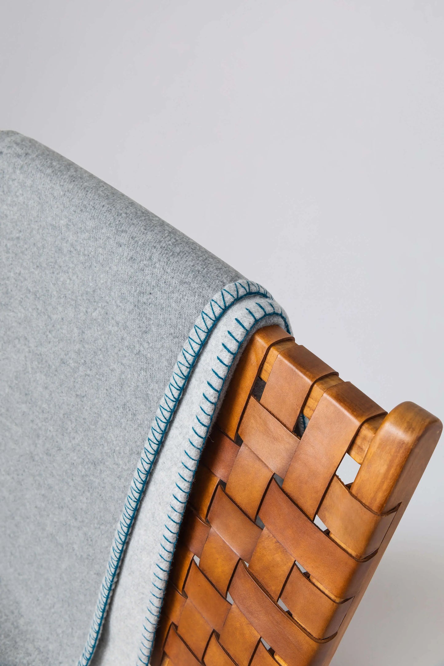 2025 Johnstons of Elgin Interiors Collection Silver & Grey Reversible Blanket Stitched Throw detail shot of teal blanket stitching TB000500RU7560ONE