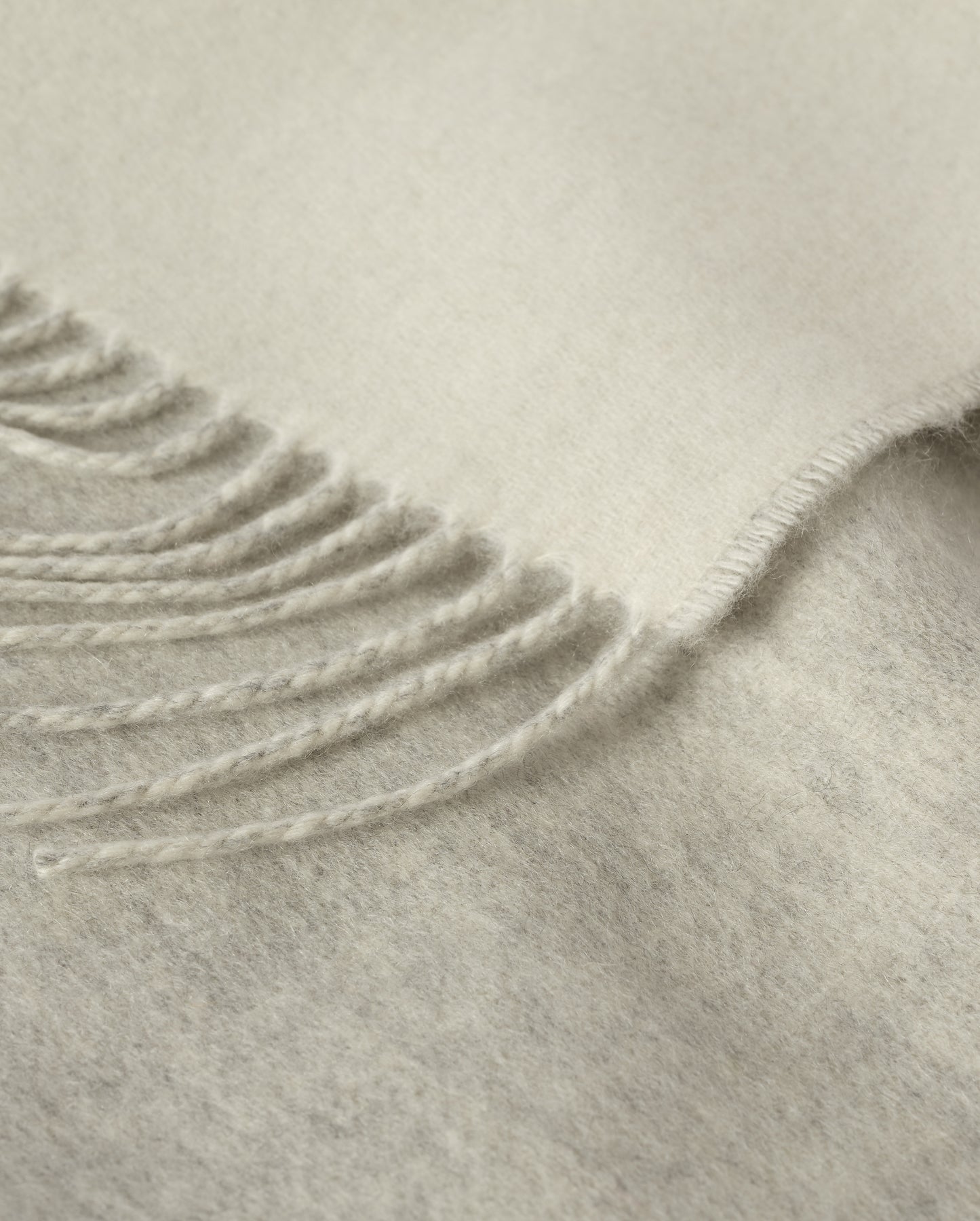 Johnstons of Elgin Interiors Collection Reversible Silver & White Cashmere Throw on a wooden chair WA000013RU5059ONE