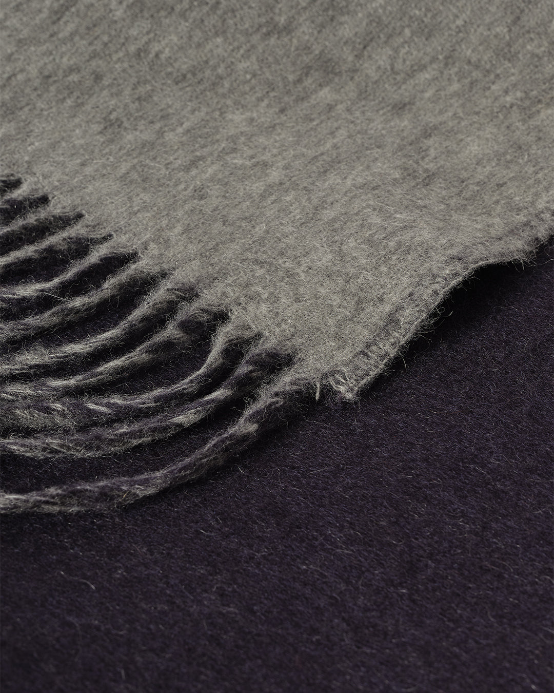 Johnstons of Elgin Interiors Collection Reversible Navy & Light Grey Cashmere Throw on a wooden chair WA000013RU6632N/A