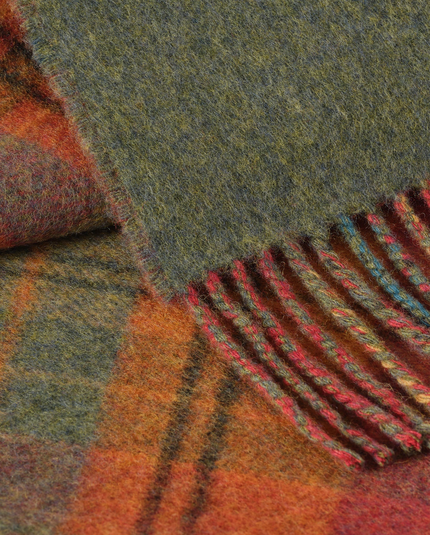 Johnstons of Elgin Interiors Collection Red Tweed & Green Windowpane Reversible Lambswool Throw on a grey background WD000021XU0036N/A