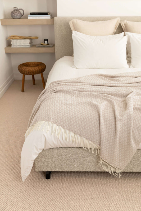 Johnstons of Elgin’s Lattice Weave Merino Bed Throw in Light Taupe & White on bed in neutral bedroom WD001243RU7268ONE