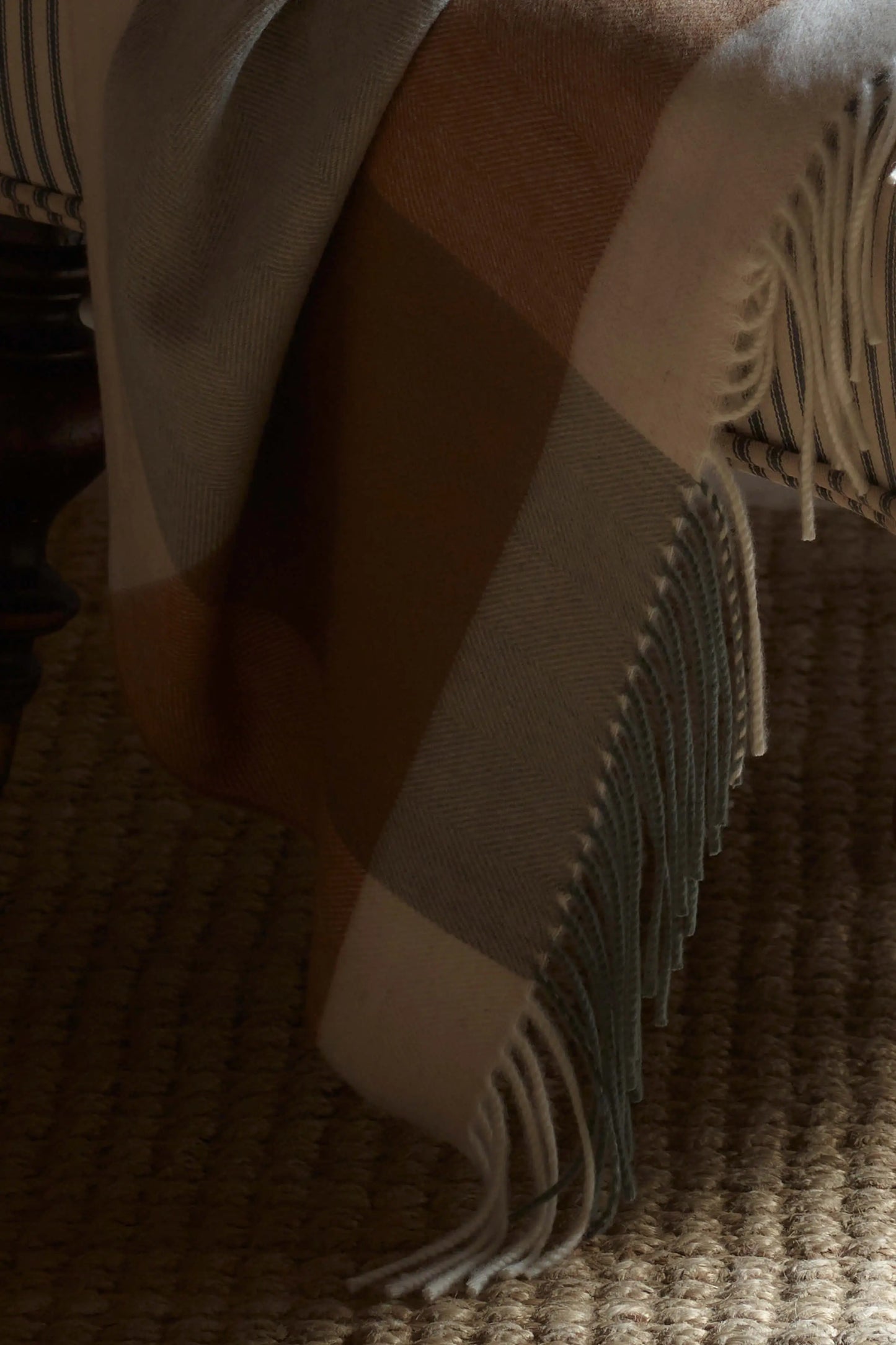 2025 Johnstons of Elgin Interiors Collection Warm Block Border Wool Throw draped on a bed WDC01871RU7452ONE