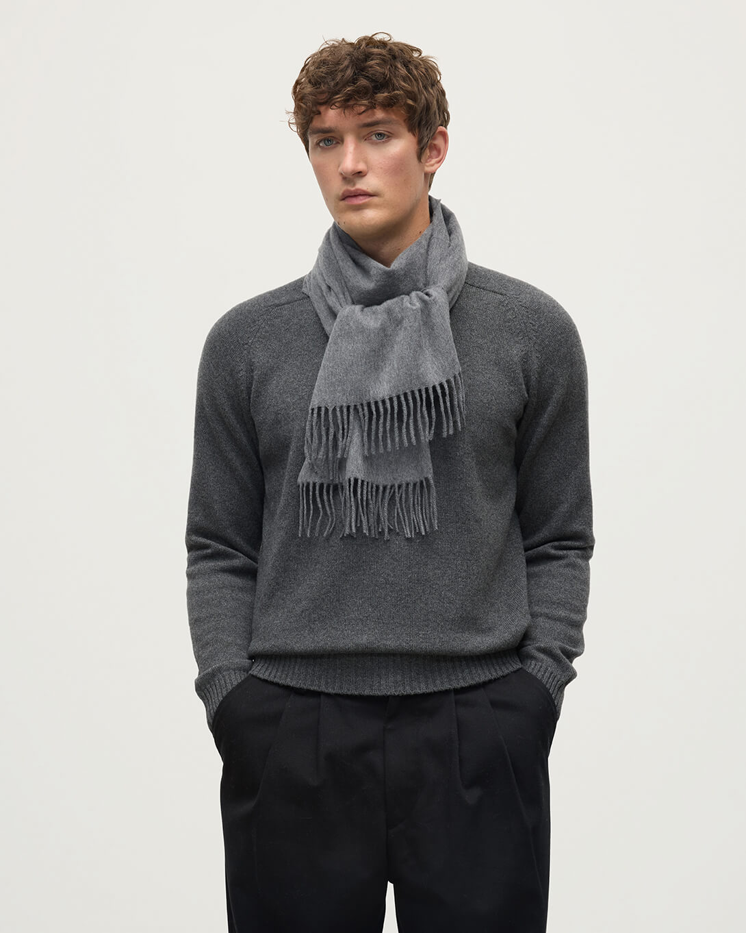 Model wearing Johnstons of Elgin AW25 Woven Accessories Mid Grey Merino Wool Grey Scarf WDC01797HA0501ONE
