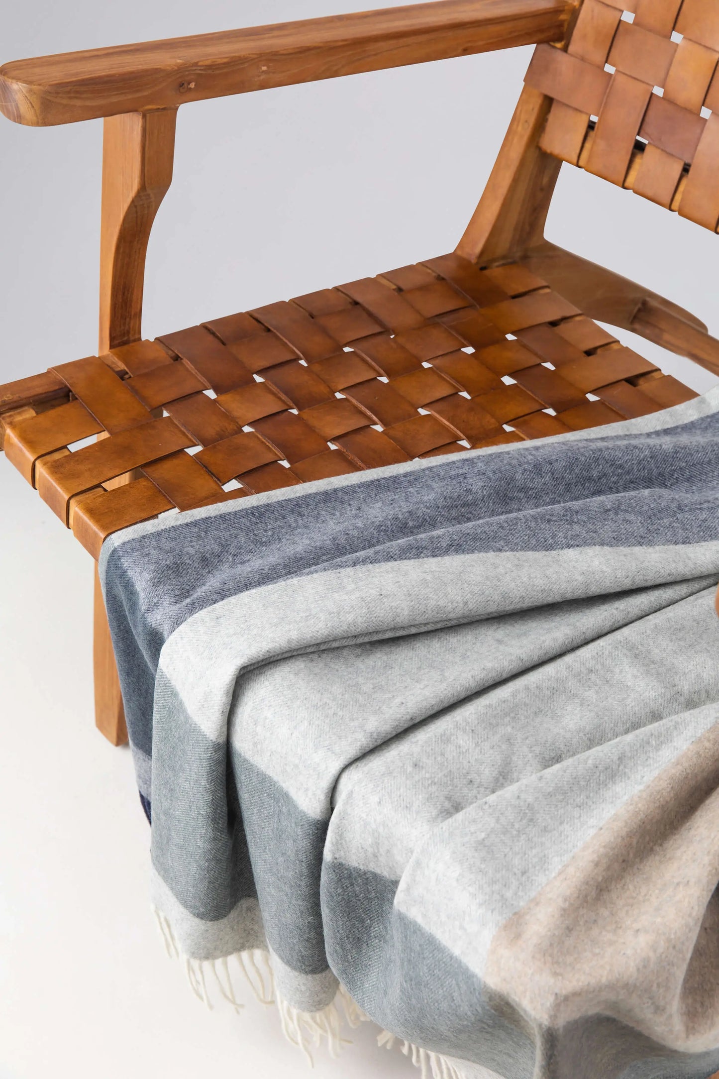 2025 Johnstons of Elgin Interiors Collection Cool Block Border Wool Throw on a grey background WDC01871RU7453ONE