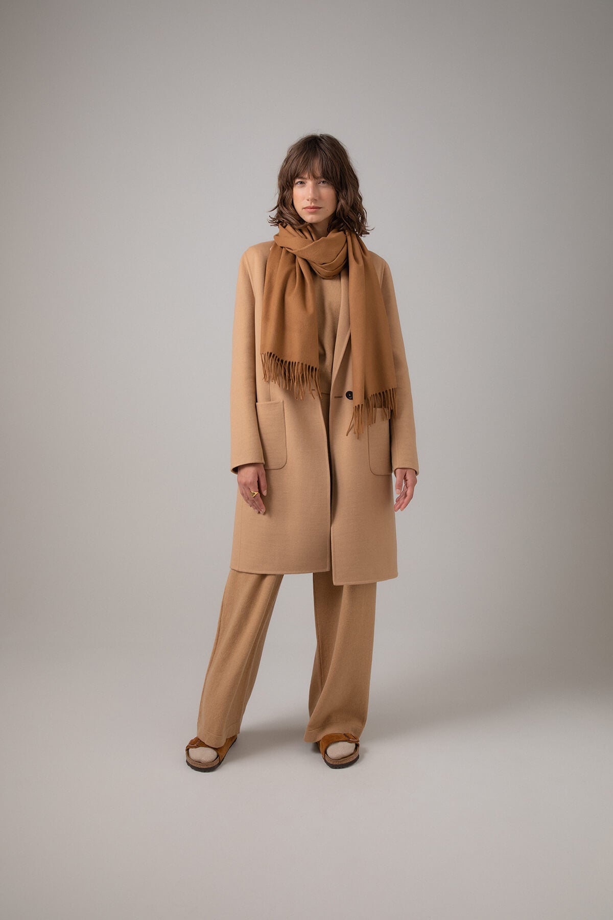 Johnstons of Elgin Pure Vicuña Stole worn with a Camel Cashmere Coat on a grey background WR000024SB3022N/A