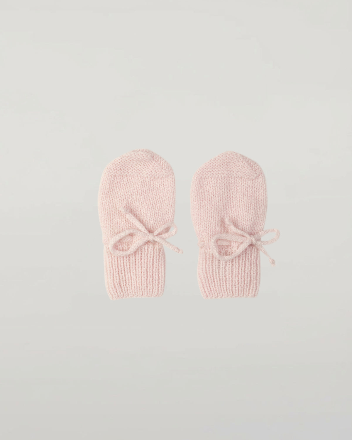 Johnstons of Elgin Hand Knitted Cashmere Baby Mittens in Blush on white background JA000108SE0208ONE