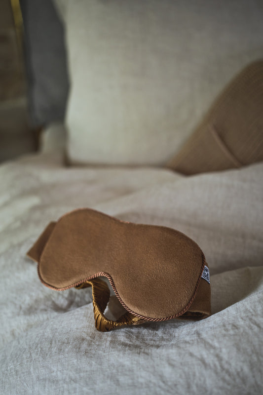 Johnstons of Elgin Cashmere Eye Mask with Silk Lining in Camel on bed TA0003407310ONE