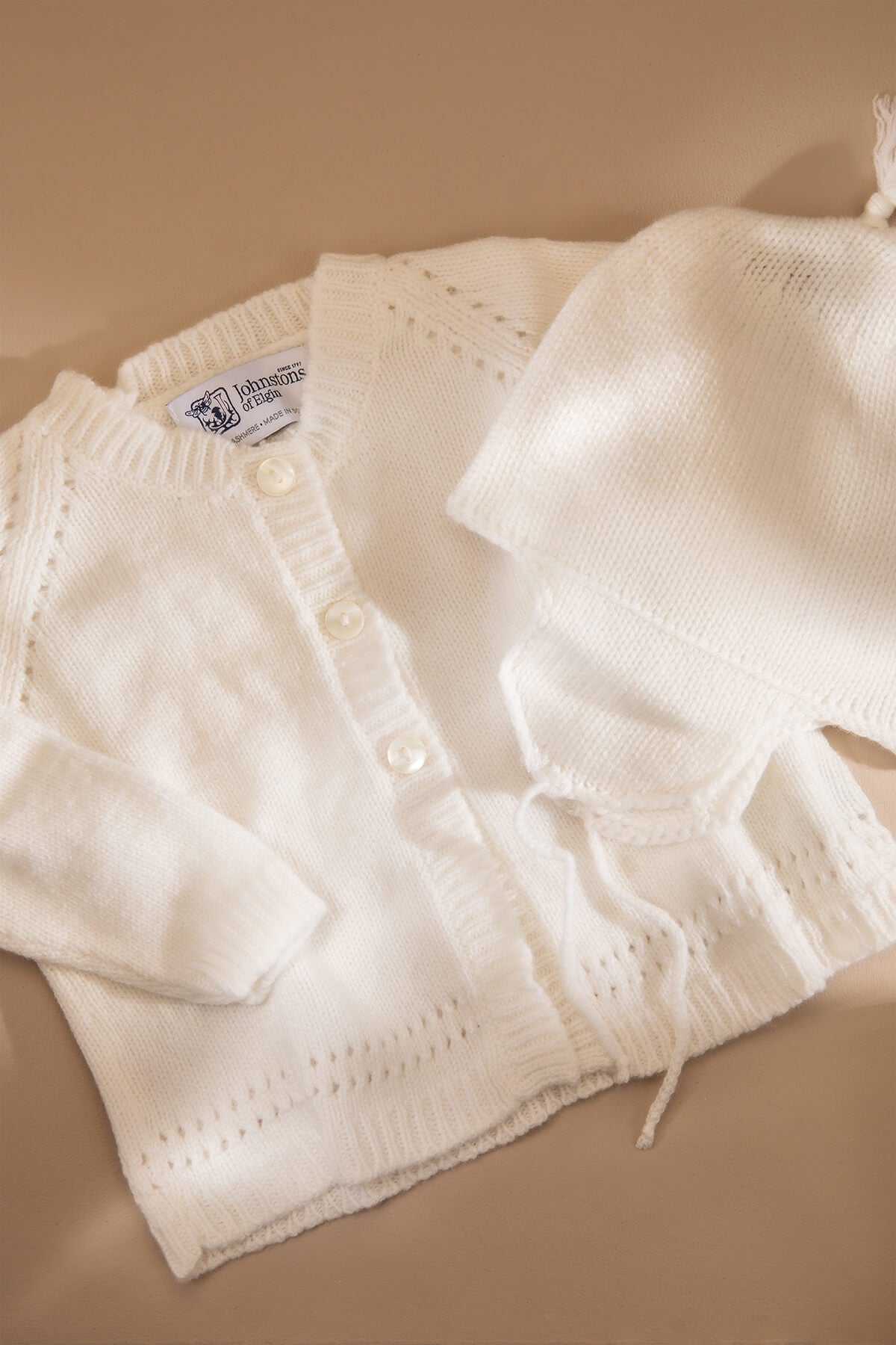 Johnstons of Elgin’s Baby's 1st Cashmere Cardigan Gift Set in Ecru on a beige background AW21GIFTSET19A