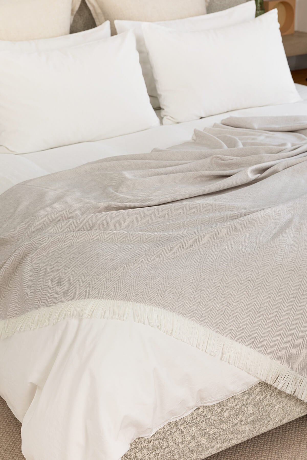 Johnstons of Elgin’s Herringbone Merino Bed Throw in Mist & White on bed WD001115RU5856ONE