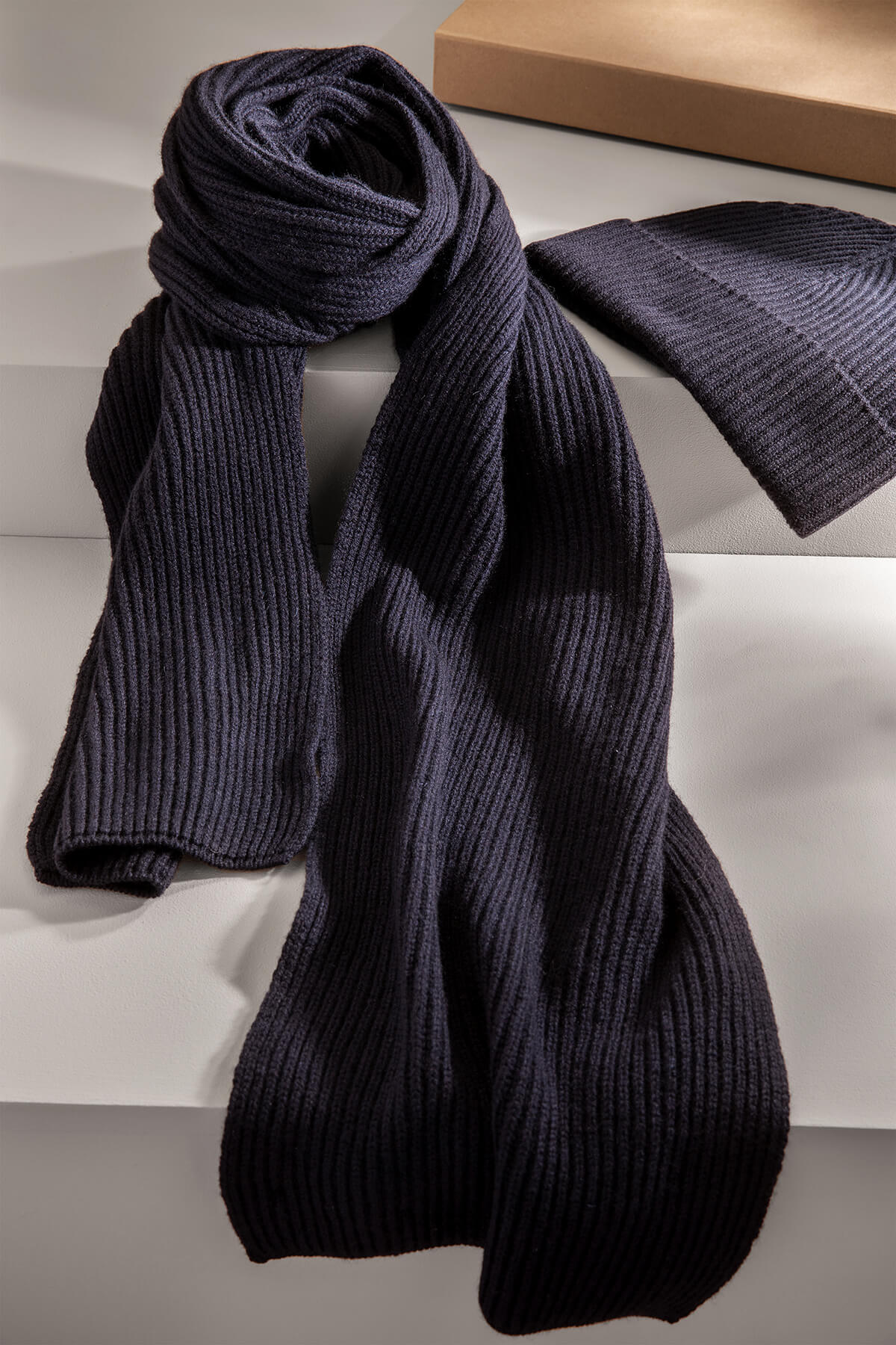 Johnstons of Elgin’s Ribbed Cashmere Beanie and Scarf Giftset in Navy on a grey background AW23GIFTSET6B