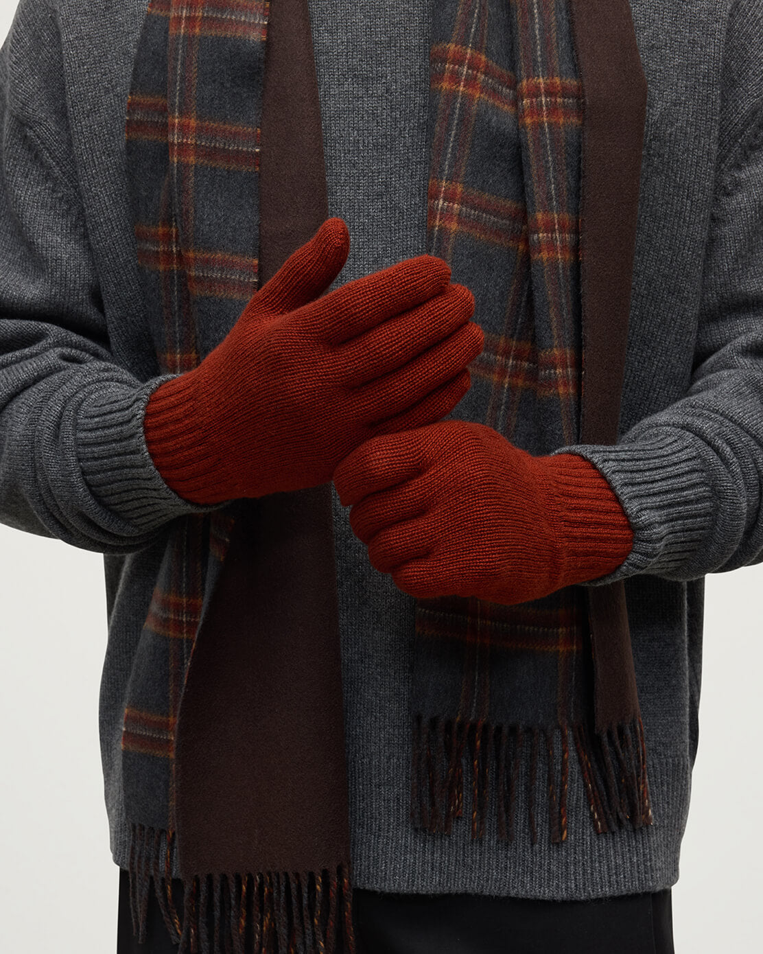Model wears Johnstons of Elgin men's red cashmere gloves HAY01001SG4463ONE