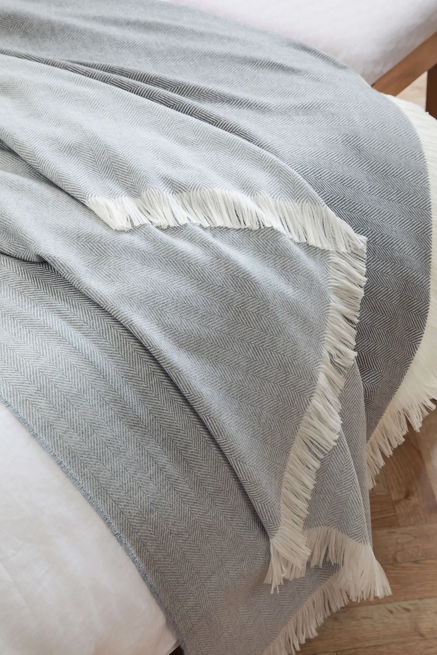 2025 Johnstons of Elgin Interiors Collection Mist & White Herringbone Merino Bed Throw close up  WD001115RU5857ONE