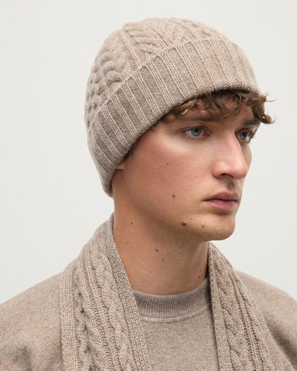 Model wears Johnstons of Elgin AW25 Knitted Accessories Ash Aran Cable Brown Cashmere Beanie HAC03411HB4334ONE