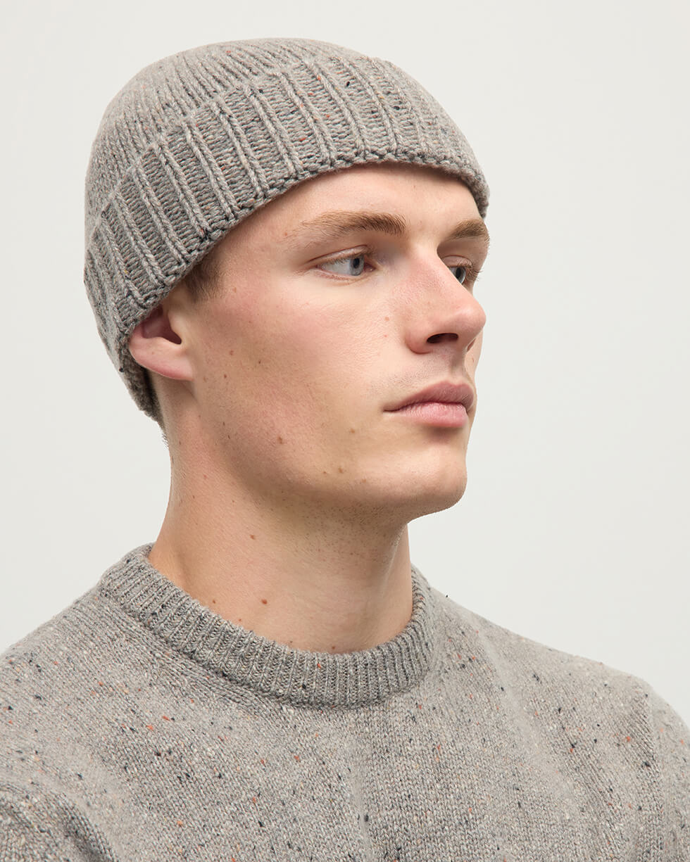 Model wearing Johnstons of Elgin AW25 Knitted Accessories Peregrine Donegal Cashmere Brown Beanie HAC03525006335ONE