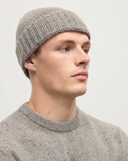 Model wearing Johnstons of Elgin AW25 Knitted Accessories Peregrine Donegal Cashmere Brown Beanie HAC03525006335ONE