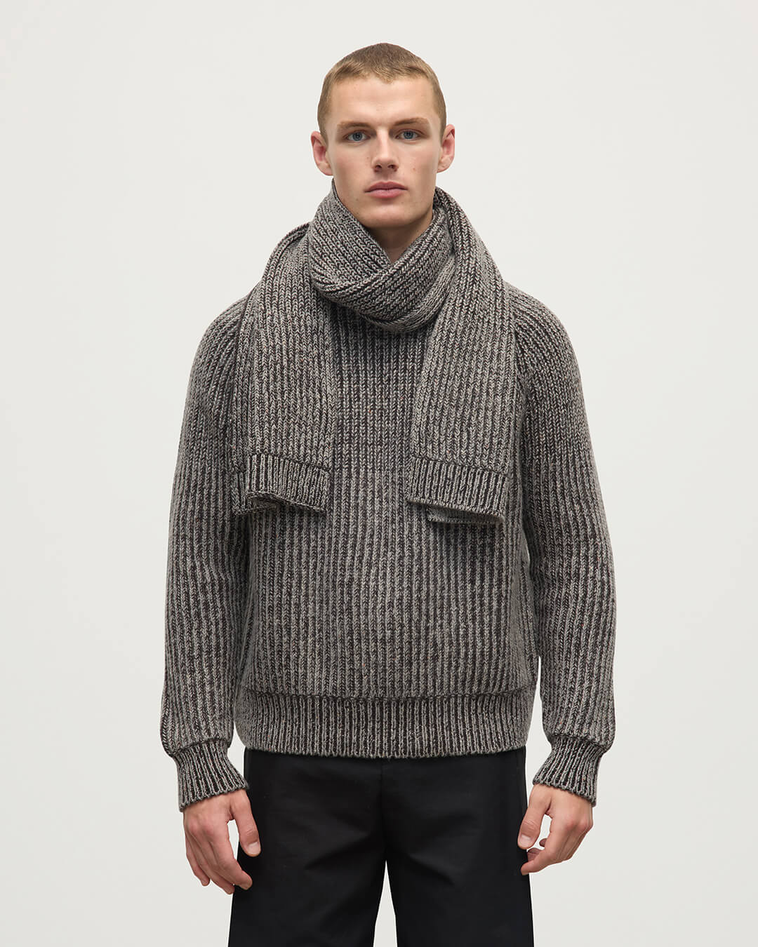 Model wears Johnstons of Elgin AW25 Knitted Accessories Peregrine Donegal Cashmere Brown Knitted Scarf HAC03530Q25314ONE