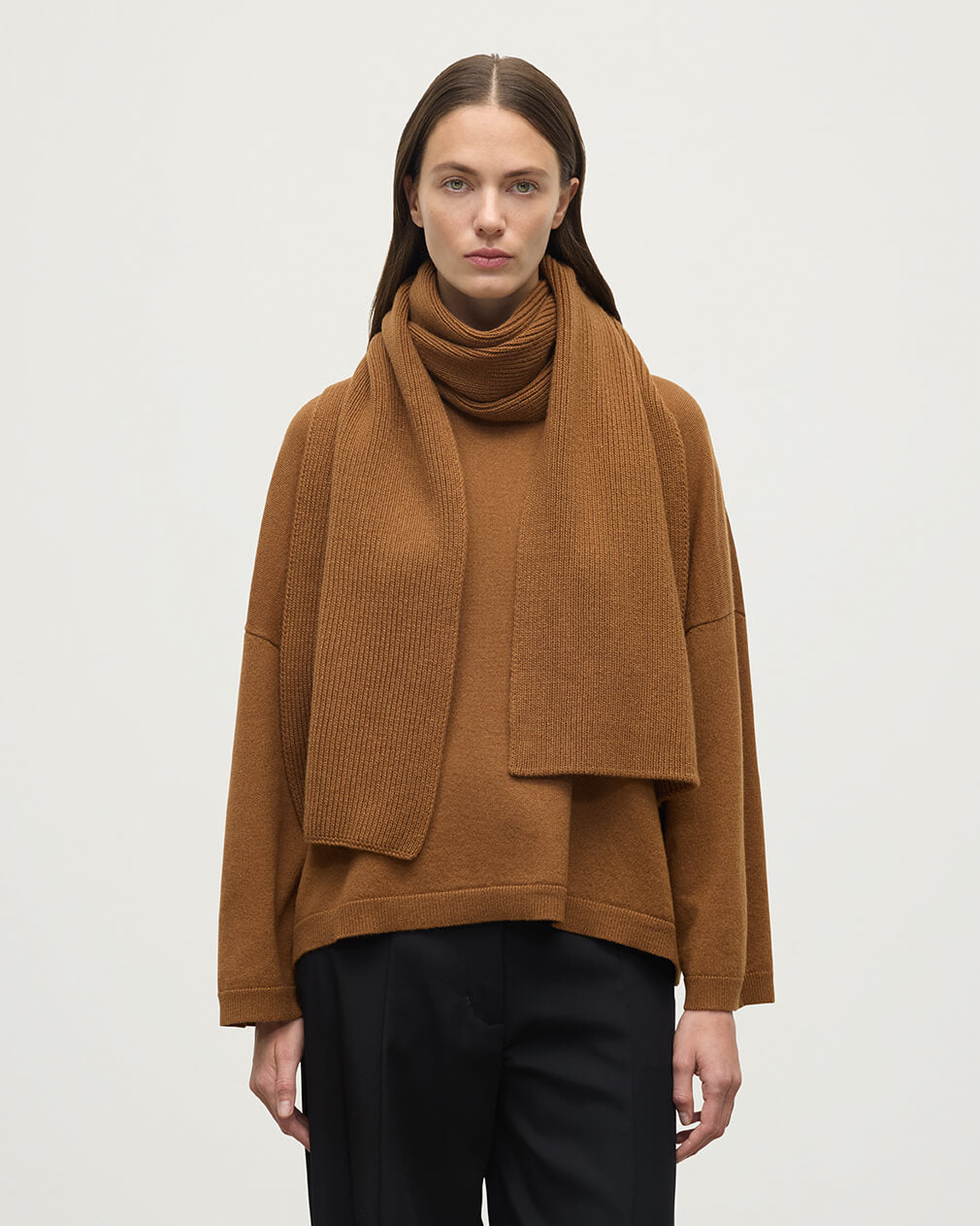 Model wears Johnstons of Elgin AW25 Knitted Accessories Dark Camel Ribbed Camel Cashmere Scarf HAC03537SB4620ONE