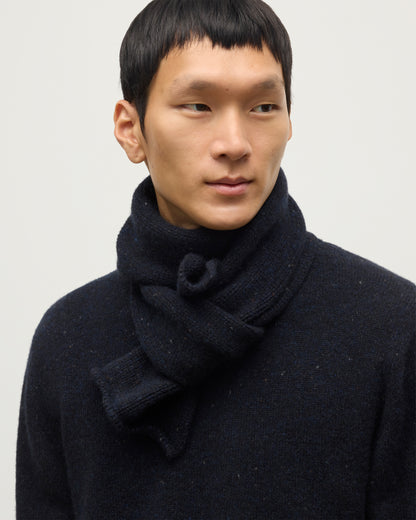 MODEL WEARING JOHNSTONS OF ELGIN TIREE SCARF 100% CASHMERE  WITH MATCHING TIREE CASHMERE SWEATER IN NORTHSCAPE DONEGAL HAC03622HD7348ONE