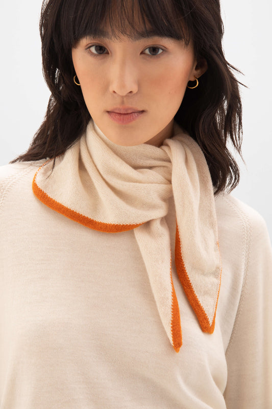 Model wearing Johnstons of Elgin Knitted Accessories  Double Faced Cream Cashmere Triangle Scarf with cream cable sweater HAE02939Q24452ONE