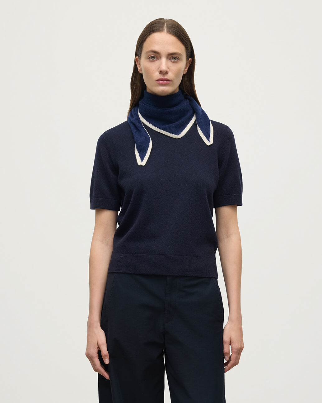 Model wearing Johnstons of Elgin Knitted Accessories  Double Faced Navy Cashmere Triangle HAE02939Q24454ONE