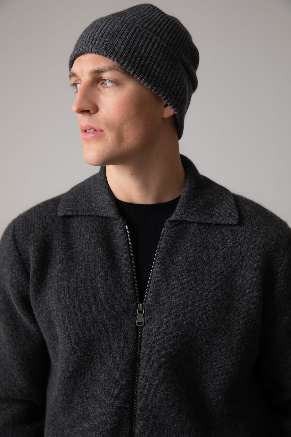 Johnstons of Elgin’s Mid Grey Slouchy Ribbed Cashmere Beanie worn by a Male on grey background HAE03325HA4181