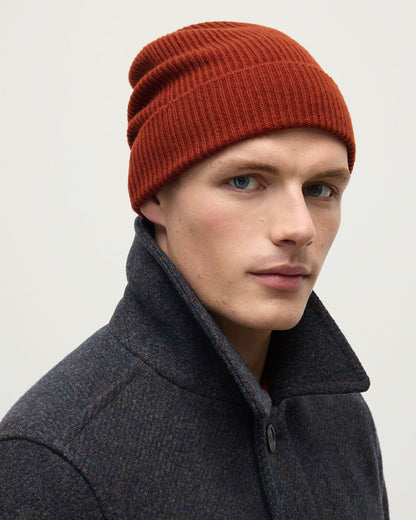 male model wearing Johnstons of Elgin Red Cashmere Beanie Hat HAE03325SG4463ONE